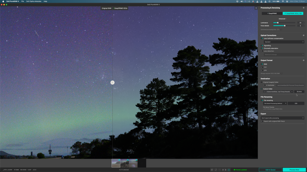 Screenshot of DxO PureRAW 4 showing a before/after noise-reduction comparison on a night-sky photo with stars, a meteor streak, and silhouetted trees against a faint aurora glow.