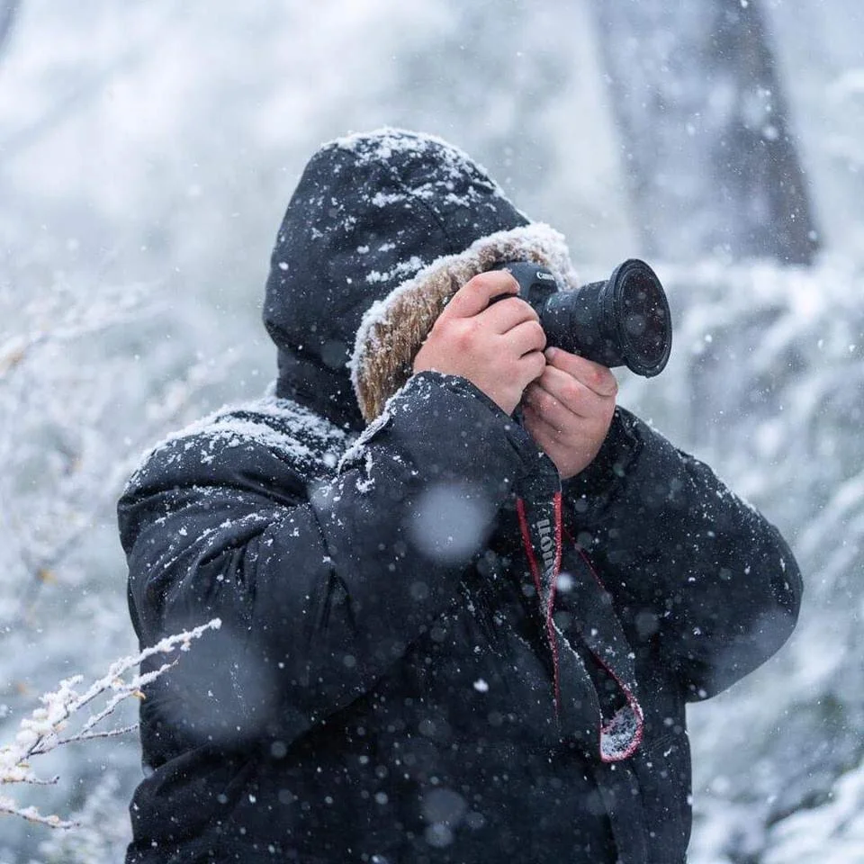 Ben is pictured in full snow gear with amongst a heavy snowfall, with a camera obscuring his face